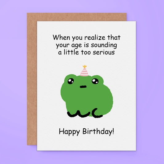 Funny birthday card featuring a frog wearing a party hat with the text “When you realize that your age is sounding a little too serious. Happy Birthday!”