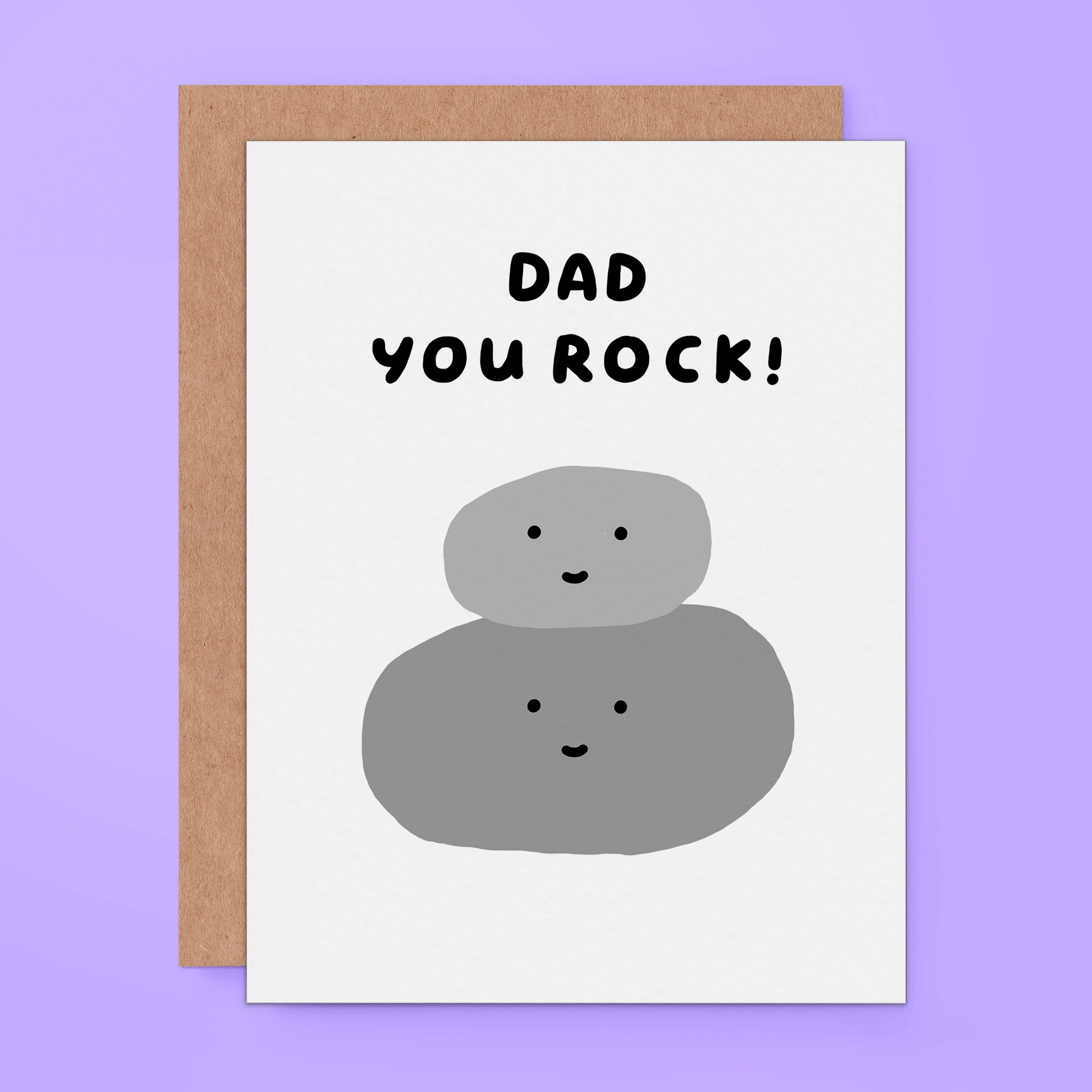A cute card for fathers featuring two smiling, stacked rocks with the text "DAD YOU ROCK!." The card has a simple hand-drawn style