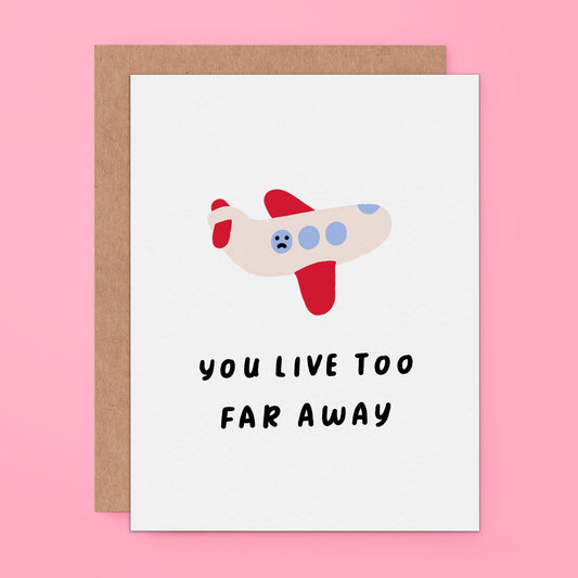 Greeting card with a cute illustration of a sad-faced airplane above the text 'You Live Too Far Away' 