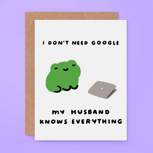 A greeting card featuring a cute green frog illustration next to a gray laptop and the text 'I DON'T NEED GOOGLE MY HUSBAND KNOWS EVERYTHING' on a light purple background.